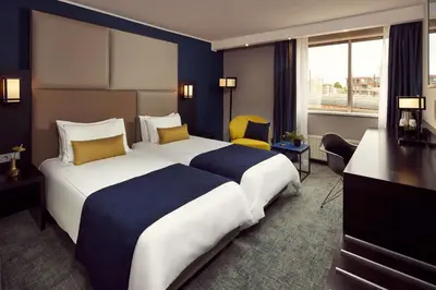 a hotel room with a large bed and a desk at Park Plaza Utrecht in Utrecht