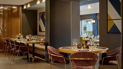 a row of tables in a restaurant with chairs at Park Plaza Utrecht in Utrecht