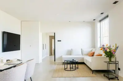 a living room with a white couch and a table at SéSé in Vinkeveen
