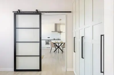 a sliding glass door leading to a kitchen with a table at SéSé in Vinkeveen