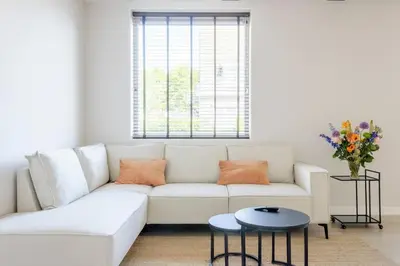 a white living room with a white couch and a table at SéSé in Vinkeveen