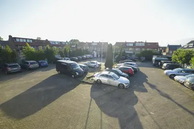 a parking lot with a bunch of parked cars at Hotel Zwanenburg Amsterdam Airport in Zwanenburg