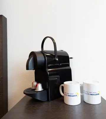 a bag and two coffee cups on a table at Bastion Hotel Almere in Almere