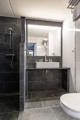 a bathroom with a sink and a mirror at Best Western Plus Amsterdam Airport Hotel in Hoofddorp