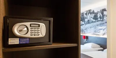 a remote control on a shelf in a hotel room at Best Western Plus Amsterdam Airport Hotel in Hoofddorp