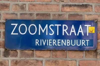 a blue street sign on a brick wall at Boutique Studio Amsterdam near RAI and De Pijp in Amsterdam