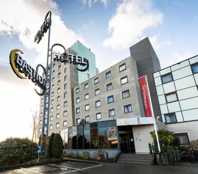 a hotel building with a sign in front of it at Bastion Hotel Amsterdam Amstel in Amsterdam