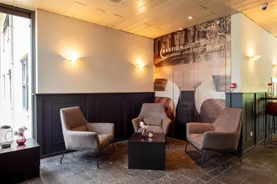 a waiting room with two chairs and a bed at Bastion Hotel Amsterdam Noord in Amsterdam