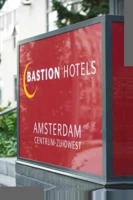 a sign for an australianiumiumcinium zimbabweost at Bastion Hotel Amsterdam Zuidwest in Amsterdam