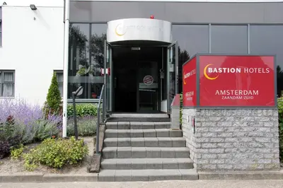 a entrance to a building with a red sign at Bastion Hotel Zaandam in Zaandam