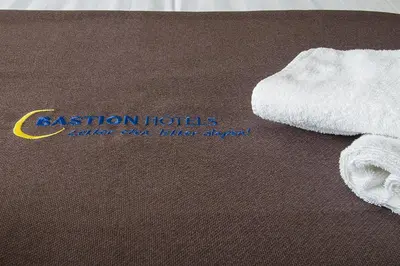 a white towel sitting on top of a table at Bastion Hotel Zaandam in Zaandam
