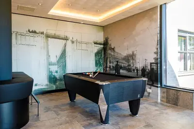a ping pong table in a room with a wall at Bastion Hotel Haarlem Velsen in Santpoort-Noord