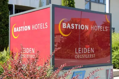 a billboard for a boston hotel in front of a building at Bastion Hotel Leiden Oegstgeest in Oegstgeest