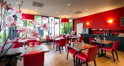 a restaurant with red walls and tables and red chairs at Bastion Hotel Leiden Voorschoten in Leiden