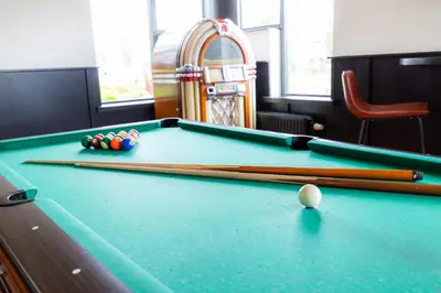 a pool table with cue balls and balls on it at Bastion Hotel Leiden Voorschoten in Leiden