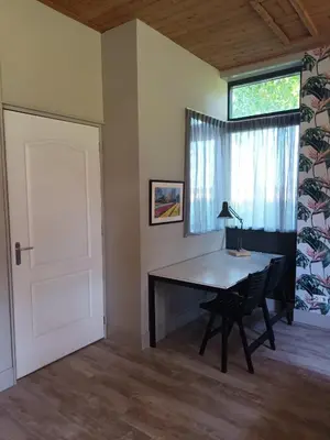 a room with a desk and a window and a door at Bollenboet in Sint Maarten