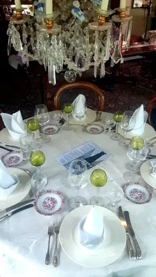 a white table with plates and glasses on it at Villa Zomerdijk in Velsen-Zuid