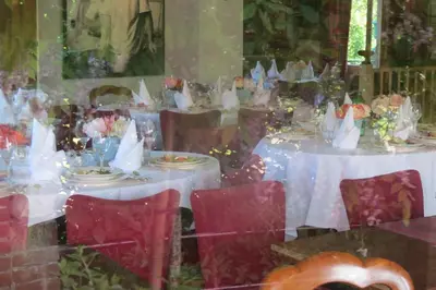 a table set up for a wedding with white tables and chairs at Villa Zomerdijk in Velsen-Zuid