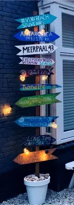 a christmas tree with signs on the side of a building at Meerpaal 43 Bergen in Bergen