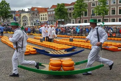 two men in green hats walking around orange barrels at Meerpaal 43 Bergen in Bergen