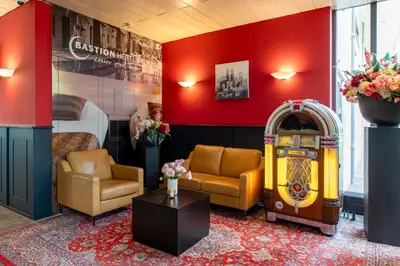 a room with a pinball machine and a bed at Bastion Hotel Schiphol Hoofddorp in Hoofddorp