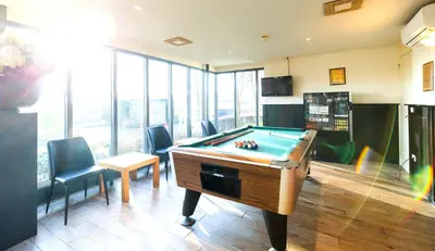 a billiard room with a pool table and chairs at Bastion Hotel Schiphol Hoofddorp in Hoofddorp