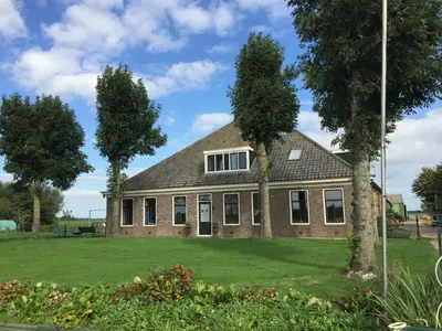 a house with two trees in front of it at Vakantiehuis Overleek in Monnickendam