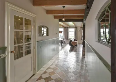 a hallway of a home with a door and a staircase at Vakantiehuis Overleek in Monnickendam