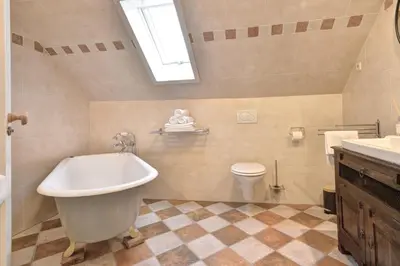 a bathroom with a tub and a toilet and a sink at Vakantiehuis Overleek in Monnickendam