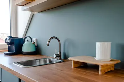 a kitchen counter with a sink and a window at Albatros aan Zee - Studio in Zandvoort