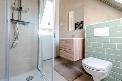 a bathroom with a toilet and a shower at Albatros aan Zee - Studio in Zandvoort