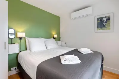 a bedroom with a bed with two towels on it at Amsterdam Dunes Holiday Home in Zandvoort