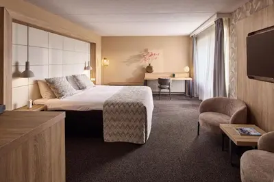 a hotel room with a bed and a tv at Van der Valk Hotel Leusden - Amersfoort in Leusden