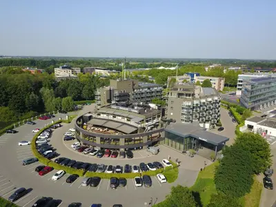 an aerial view of a parking lot in a city at Van der Valk Hotel Leusden - Amersfoort in Leusden
