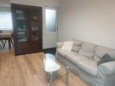 a living room with a couch and a table at House with garden in the center close to the sea and Amsterdam in Beverwijk