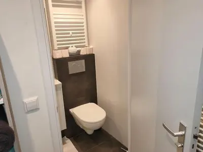 a small bathroom with a toilet and a window at House with garden in the center close to the sea and Amsterdam in Beverwijk