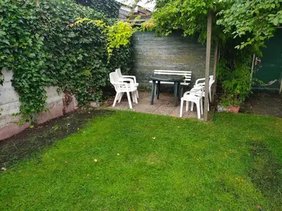 a patio with a table and chairs in a yard at House with garden in the center close to the sea and Amsterdam in Beverwijk