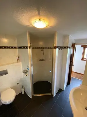 a bathroom with a shower and a toilet and a sink at La Luna - Gino in Heerhugowaard