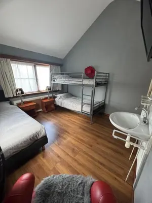 a bedroom with two bunk beds and a sink at La Luna - Gino in Heerhugowaard