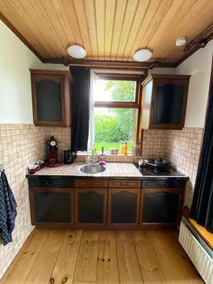 a kitchen with a sink and a window at La Luna - Gino in Heerhugowaard