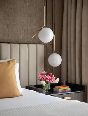 a bedroom with a bed and a table with flowers at Anantara Grand Hotel Krasnapolsky Amsterdam in Amsterdam