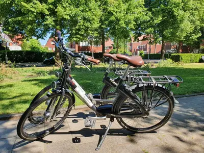 a bike parked on a stand in a park at Apollofirst Boutique Hotel in Amsterdam
