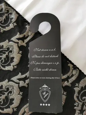 a black object with a card on a blanket at Apollofirst Boutique Hotel in Amsterdam