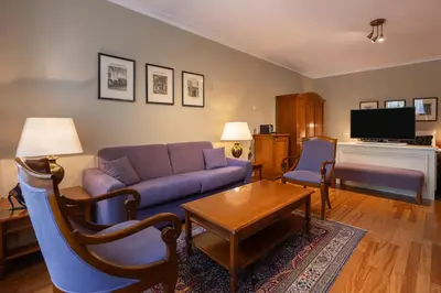 a living room with a couch and a table at Apollofirst Boutique Hotel in Amsterdam