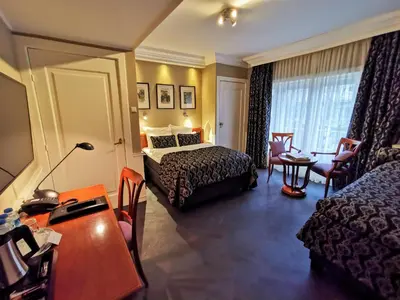 a hotel room with a bed and a desk at Apollofirst Boutique Hotel in Amsterdam