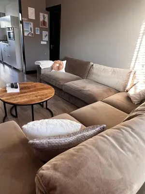 a living room with a couch and a table at Casa Xabia in Zaandam