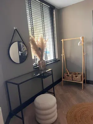 a room with a desk with a mirror and a stool at Casa Xabia in Zaandam