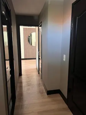 a hallway with two doors and a wooden floor at Casa Xabia in Zaandam