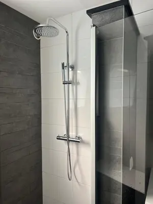 a shower with a glass door in a bathroom at Casa Xabia in Zaandam
