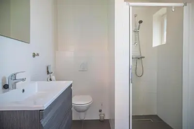a white bathroom with a sink and a toilet at De Beemster | Holiday park near Amsterdam in De Rijp